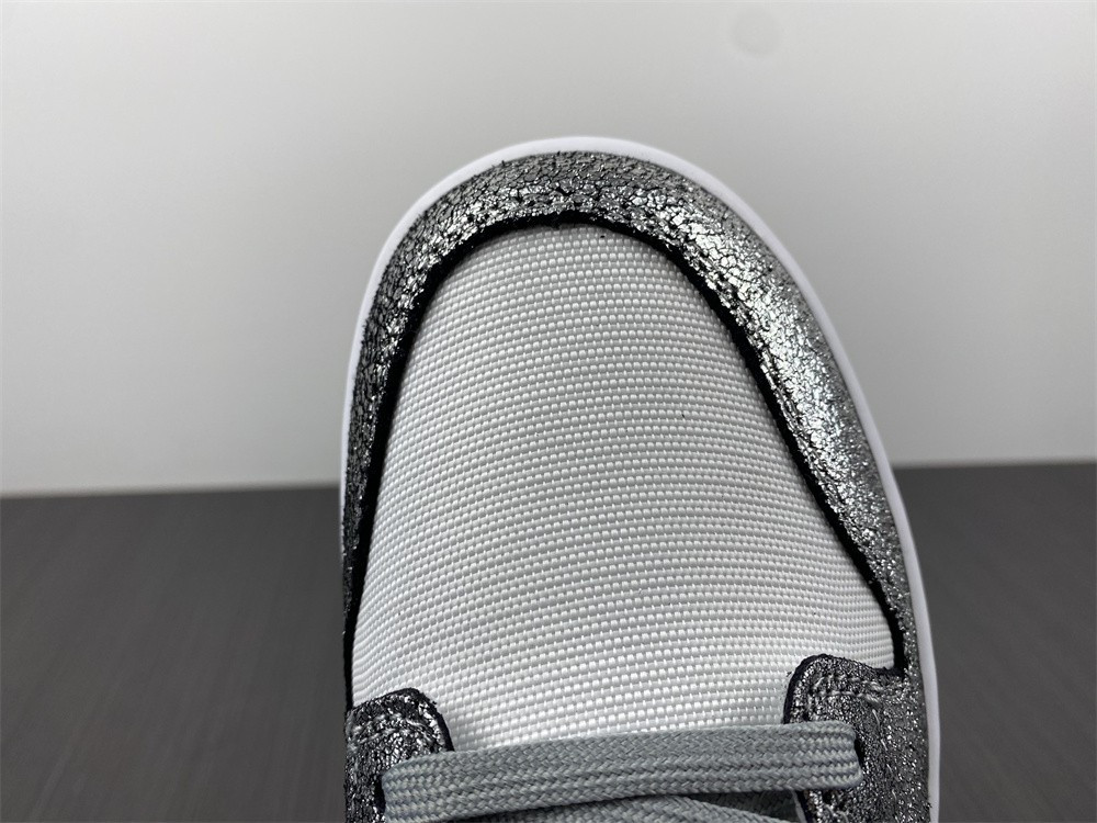 the nike dunk low features silver cracked leather do5882-001