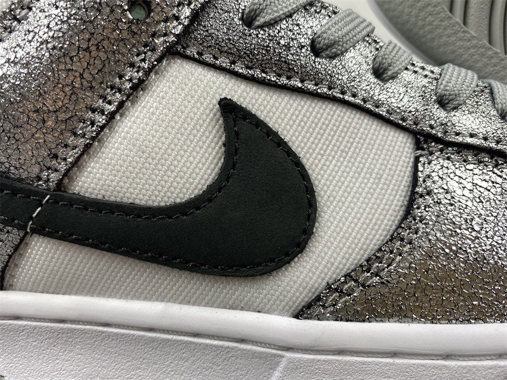 the nike dunk low features silver cracked leather do5882-001